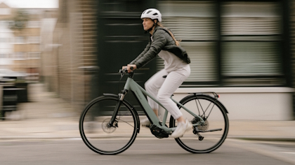 Cyclist riding across blurred background